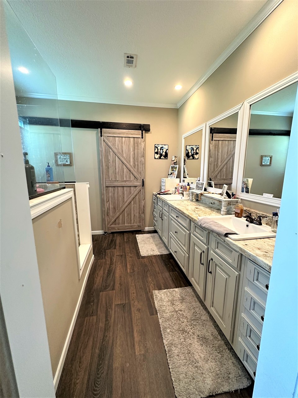master bathroom - barn door leads into bath tub room with seating area